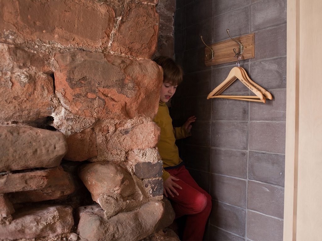 Young boy climbing down stairs at Astley Castle