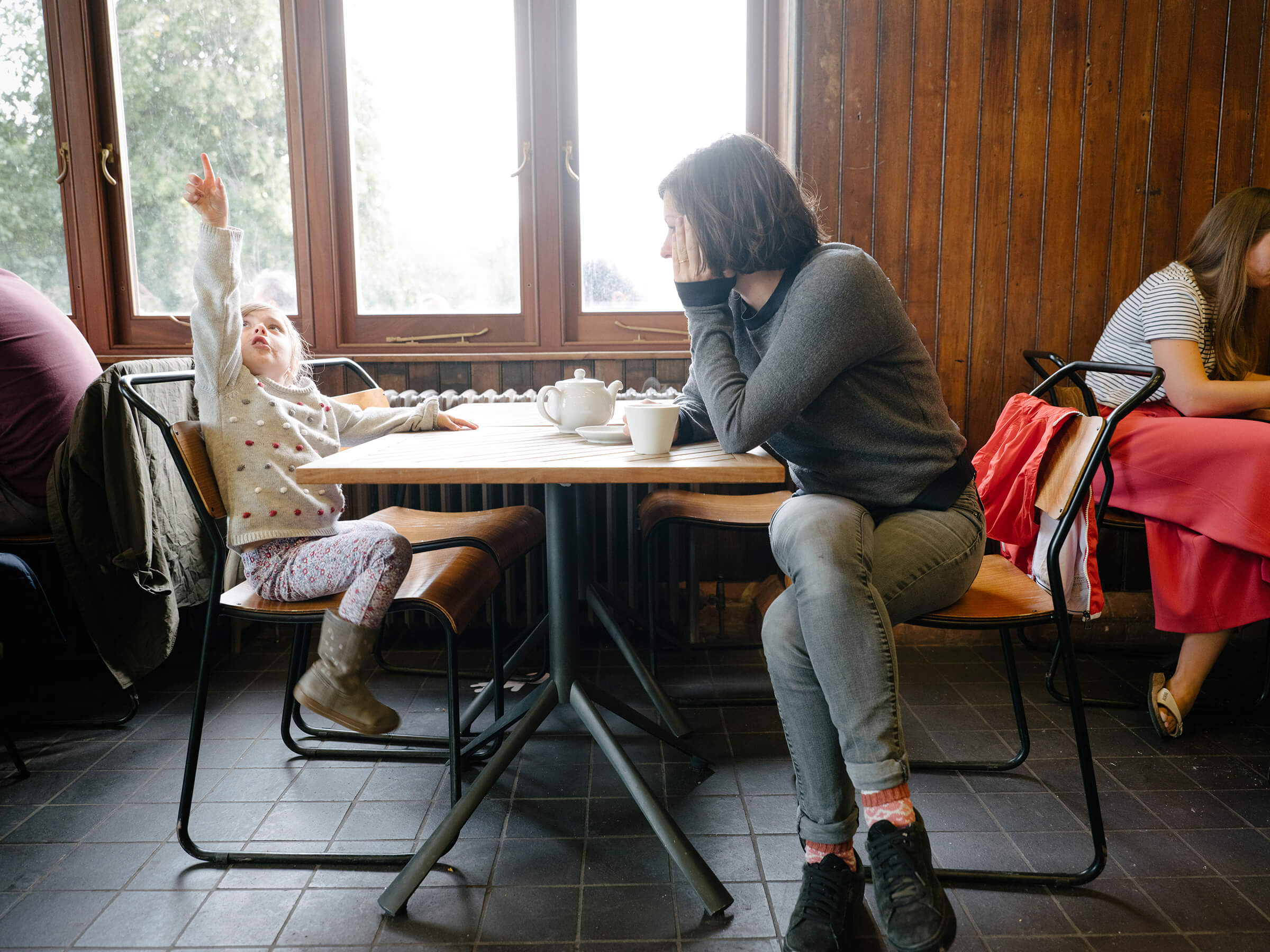 Mother and daughter sat inside cafe