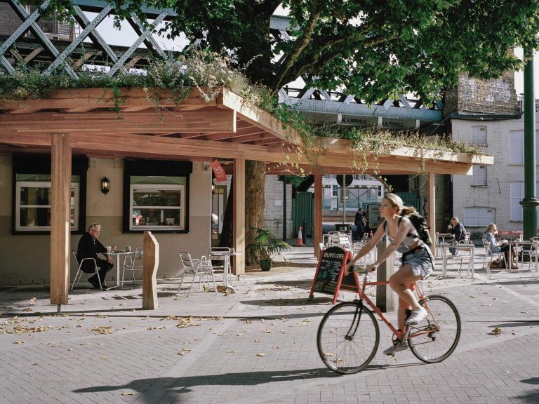 Woman cycling through Flat Iron Square